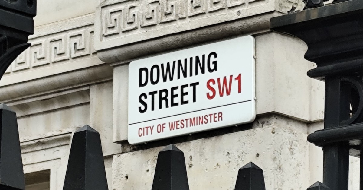 A zoomed in photo of a sign that reads "Downing Street SW1, City of Westminster"