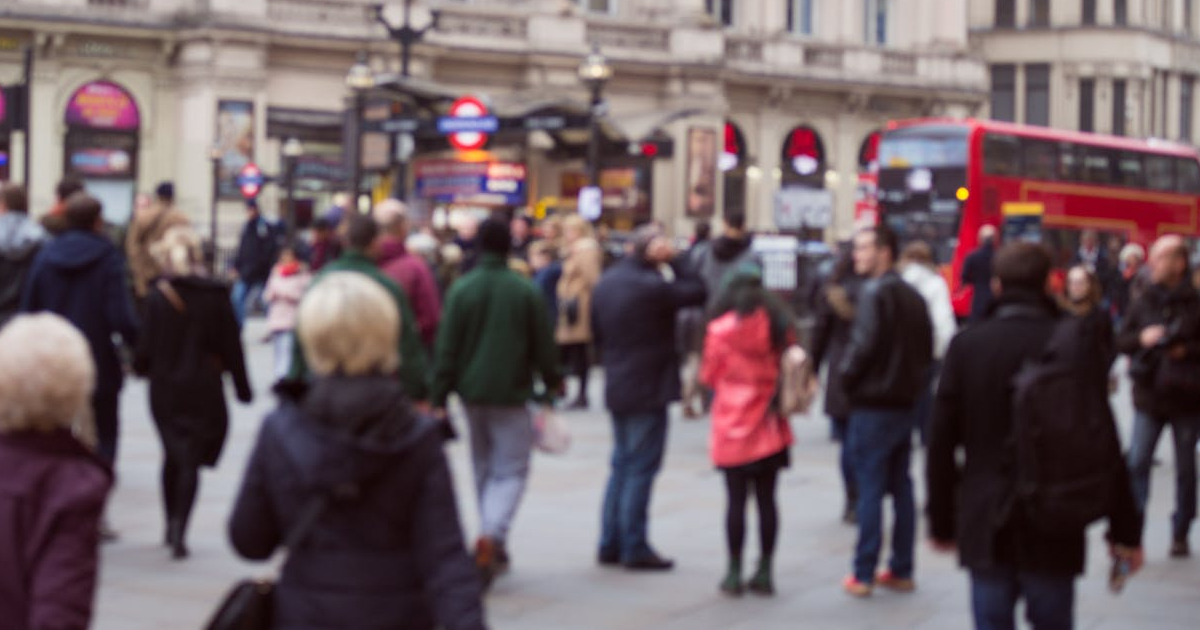 An out of focus photo taken at head height of a busy London street.